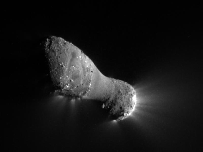 [Comet Hartley 2 as imaged by NASA's EPOXI mission (http://www.nasa.gov/mission_pages/epoxi/index.html). The comet's main body is about 1.2 miles (2 km) long but only .25 miles (.4 km) wide at its narrow neck. While the surface looks rocky like that of Vesta (above) jets of gas can be seen streaming from the comet. The jets are caused by sub-surface ices heated by sunlight (the Sun is to the right in this image). Image credit: NASA/JPL-Caltech/UMD. From http://www.nasa.gov/mission_pages/epoxi/images/hartley-3.html]